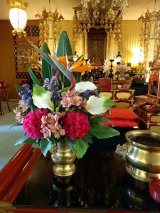 Flowers next to the incense offering bowl.